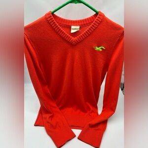 Hollister size small coral V-neck sweater. Unisex